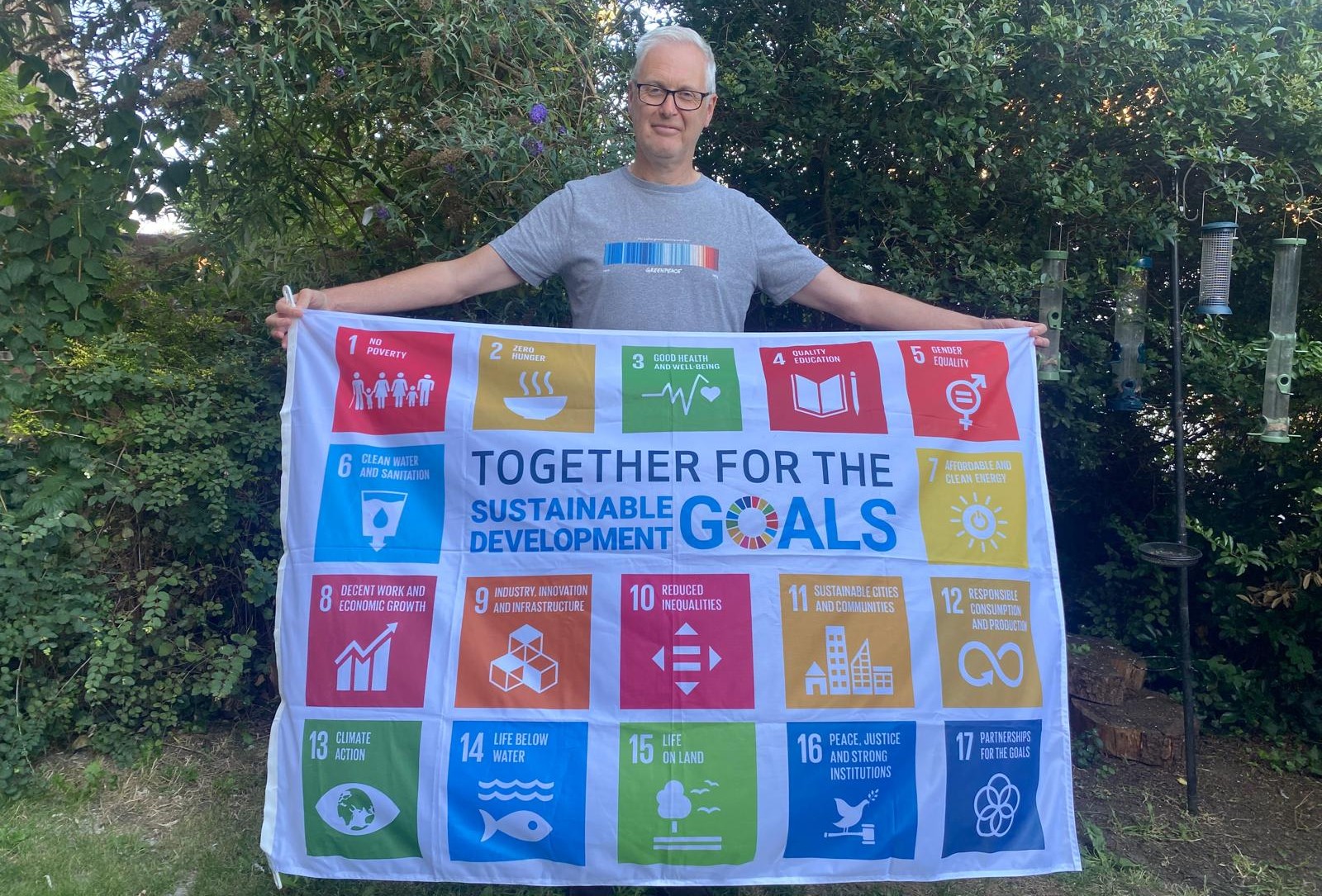 Anthony Chadwick holding the SDG Flag